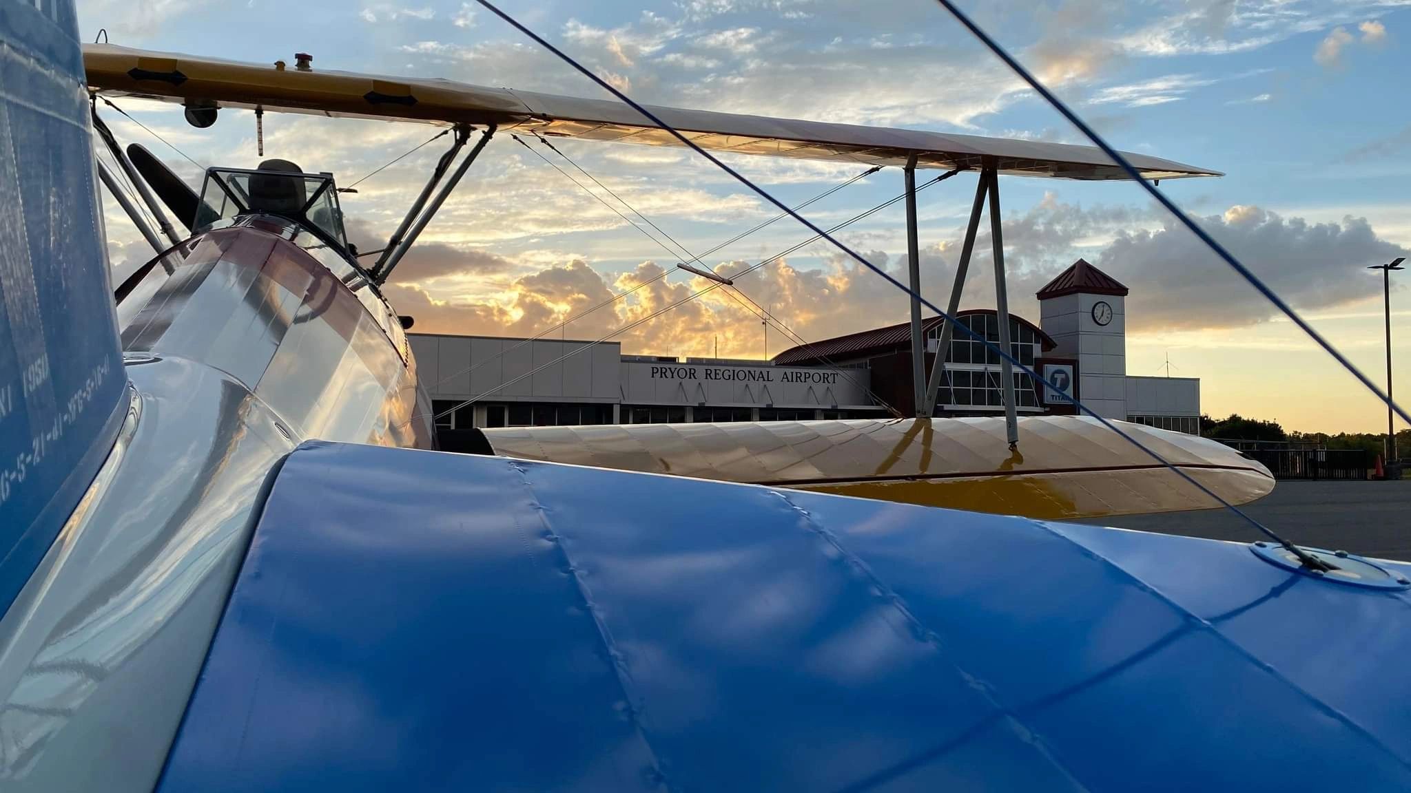 Vintage biplane at Pryor Regional Airport at sunset
